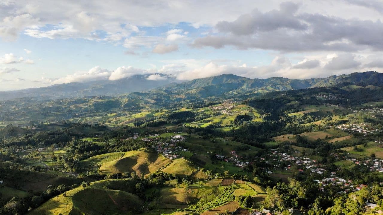 Lush green Costa Rican valley with mountains representing retirement and relocation destination